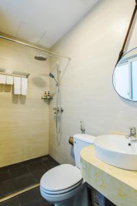 a bathroom with a toilet and a sink and a shower at Nexy Living in Hanoi +61 photos