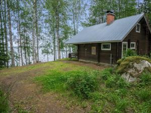 a small house sitting on top of a hill at Holiday Home Laitamökki by Interhome in Tasapää