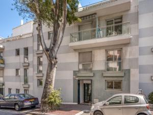 an apartment building with cars parked in front of it at Apartment Les allées du Cap-2 by Interhome in Antibes