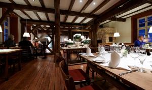 a restaurant with wooden tables and people sitting at tables at Weinhaus Henninger in Kallstadt