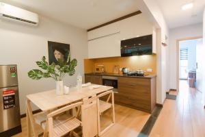 a kitchen with a wooden table with a potted plant at Nexy Living in Hanoi