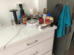 a kitchen counter with ingredients on top of it at The Urban Apartment in Haifa