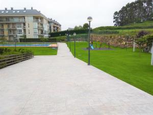 a walkway in a park next to a building at Marzan Playa in Foz