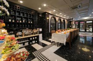 a dining room with a long table and wine bottles at Madelise Central Hotel & Travel in Hanoi