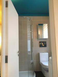 a bathroom with a toilet and a glass shower at Studio Apartment, Covent Garden in London