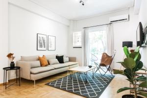 un soggiorno con divano e tavolo di Bright 2BD Apartment in Psychiko by UPSTREET ad Atene