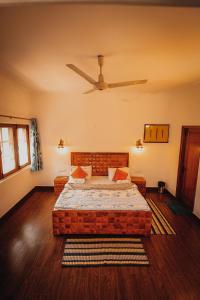 a bedroom with a bed and a ceiling fan at Moustache Delhi in New Delhi