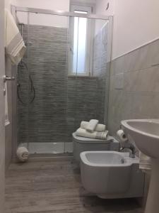 a bathroom with a shower and a toilet and a sink at Sikulè in Santa Teresa di Riva