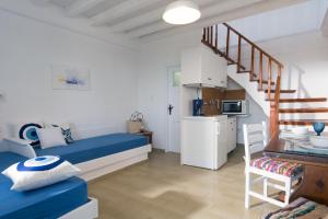 a bedroom with a blue bed and a staircase at Ferma Hill Apartments in Ferma