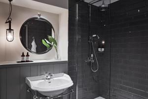 a bathroom with a sink and a shower with a mirror at Kimpton Charlotte Square, an IHG Hotel in Edinburgh