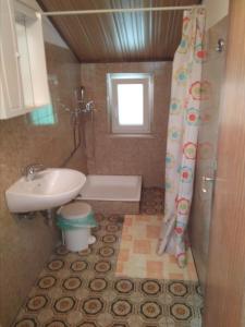 een badkamer met een wastafel, een bad en een toilet bij Gostišče Oddih in Solkan