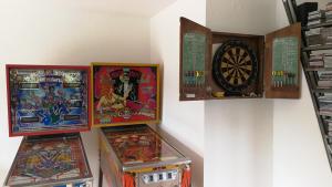 a couple of pinball machines are on a wall at Lichtblick in Vollmersbach