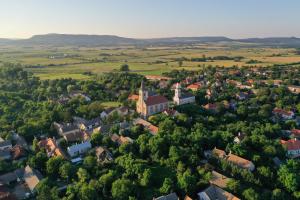 an aerial view of a small town with a church at Kemencésház Apartman in Kővágóörs
