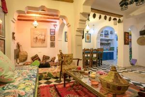 a living room with a couch and a table at Afra House in Chefchaouen