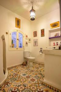La salle de bains est pourvue de toilettes et d'une fenêtre. dans l'établissement Afra House, à Chefchaouen