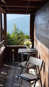 a patio with two chairs and a table with a view at App. Seeblick Top of Interlaken in Beatenberg