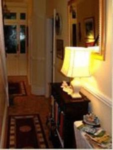 a lamp sitting on a table in a living room at Knightsrest in Burnham on Sea