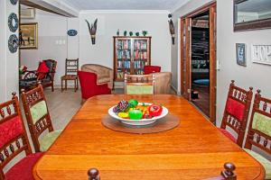 a table with a bowl of fruit on top of it at Villa Le View Guesthouse in Durban