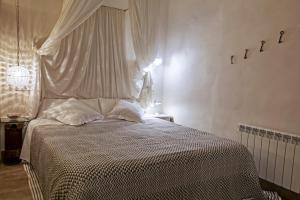 a bedroom with a bed and a night stand at El Jardinet de Sant Esteve in Olot