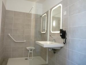 a bathroom with a sink and a mirror at L'Horloge Gourmande in Donzère