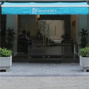 a entrance to a restaurant with a blue awning at B RESIDENCE in Beirut