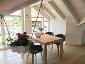 a dining room with a wooden table and chairs at Haus Vincent in Grassau