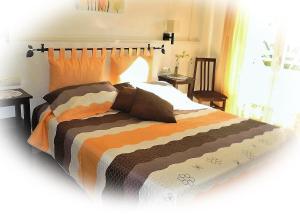 an unmade bed with a white comforter and pillows at Hostal Yebisah in Santa Eularia des Riu