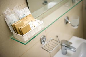 a bathroom with a sink and a shelf with books at Villa Andor in Ankaran