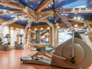 a gym with several exercise equipment in a room at Residence Les Fermes de Meribel - maeva Home in Méribel
