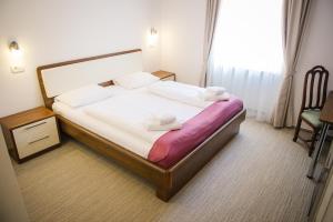 a hotel room with a bed with towels on it at Villa Andor in Ankaran