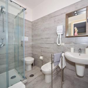 a bathroom with a sink and a toilet and a shower at Criselle in Agropoli