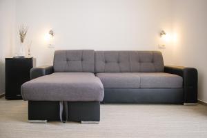 a living room with a couch and a ottoman at Villa Andor in Ankaran