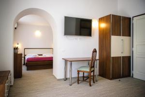a room with a table and a bed and a bedroom at Villa Andor in Ankaran