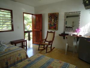 a bedroom with a bed and a desk and a mirror at Hotel Cozumel Costa Brava in Cozumel