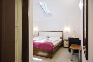 a bedroom with a bed with a teddy bear on it at Villa Andor in Ankaran