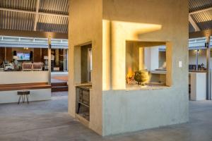 a fireplace in the middle of a room at Kalahari Farmstead in Askham