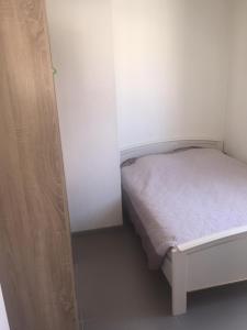 ein kleines Schlafzimmer mit einem kleinen Bett in einem Zimmer in der Unterkunft T3 à Saint cyprien plage (400m de la plage) in Saint-Cyprien