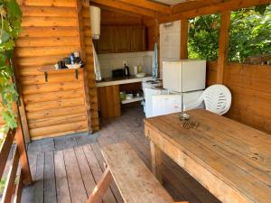 an outdoor kitchen with a table and a refrigerator at Holiday Home Kite House in Ulcinj