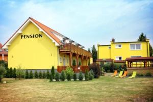 a yellow building with a sign that reads passion at Penzion Tři Koruny - budova Valerie in Havraníky