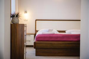 a bedroom with a bed with a purple blanket at Villa Andor in Ankaran