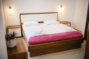 a bedroom with a large bed with white sheets at Villa Andor in Ankaran