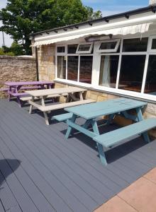 
a wooden bench sitting on top of a patio at The Bandstand in Nairn
