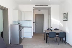 a kitchen and dining room with a table and chairs at Pansion Leggero in Krk