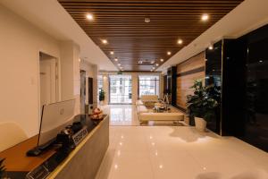 a hallway with a living room with a couch at Chotel Ben Thanh in Ho Chi Minh City