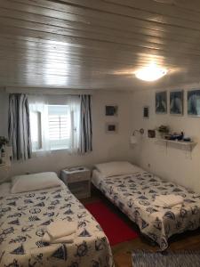 een slaapkamer met 2 bedden en een raam bij Holiday Home Listeši in Trogir