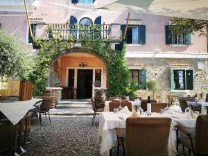 a restaurant with tables and chairs in front of a building at Villa Andor in Ankaran
