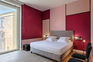 a bedroom with a large bed and a large window at Casa Pacifico Napoli in Naples