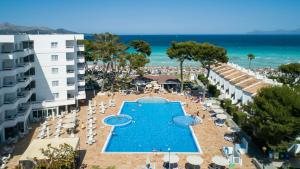 an aerial view of a resort with a swimming pool and the beach at Grupotel Los Príncipes & Spa in Playa de Muro