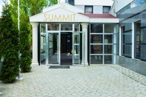 a building with a sign that reads summit at Summit Villa in Chişinău