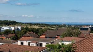 a view of roofs of houses in a city at 3 BED House w/Drive & Garden v/Fast WiFi near bioQuarter in Edinburgh